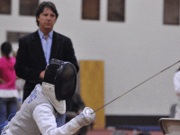 Coach Atillo Tass observes a fencing bout. Photo via Brown University