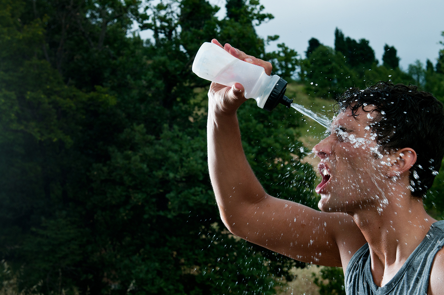Young-exhausted-athlete-splash-14508176 Water break